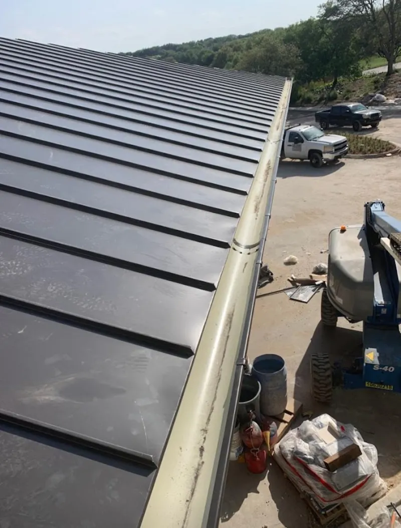 Standing seam panel and gutter detail on a metal roofing jobsite in Halfway
